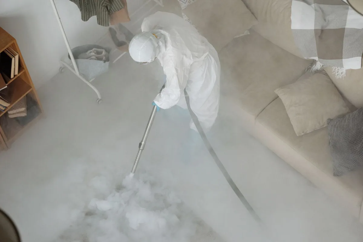 Biohazard cleanup technician in protective equipment, Henderson, TX